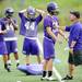 Pioneer High School football player work with a coach during the first day of practice on Monday, August 12, 2013. Melanie Maxwell | AnnArbor.com